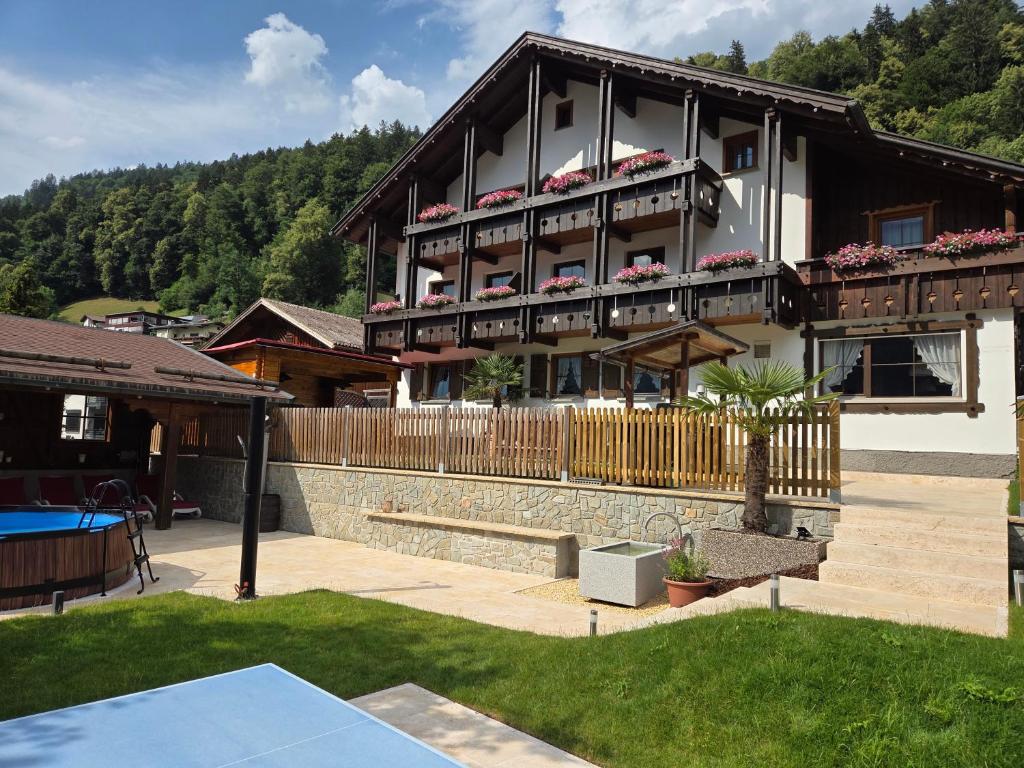 a house with a tennis court in front of it at Pension Monteneu in Bartholomäberg