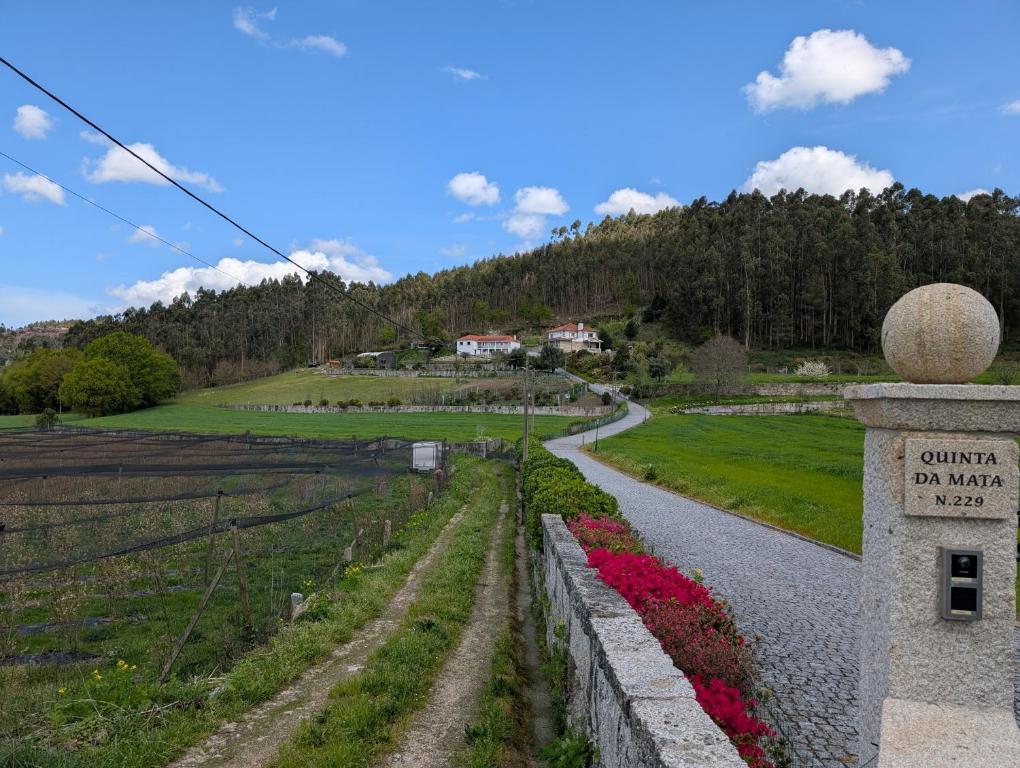 a path through a field with a sign that reads canyon on mars at Casa da Mata in Paredes de Coura