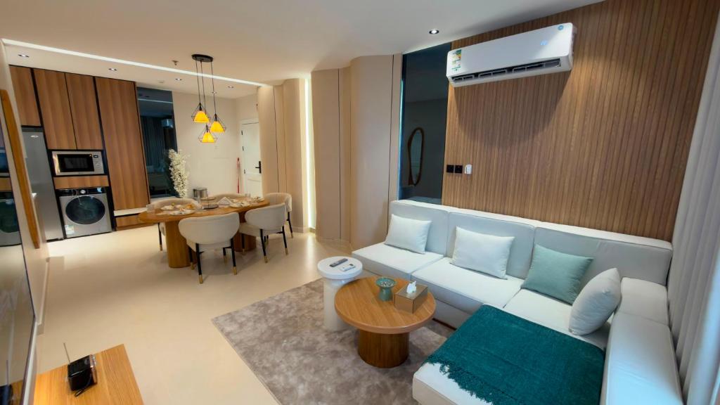 a living room with a white couch and a table at Modern 2BR Apartment in Khafji in Khafji