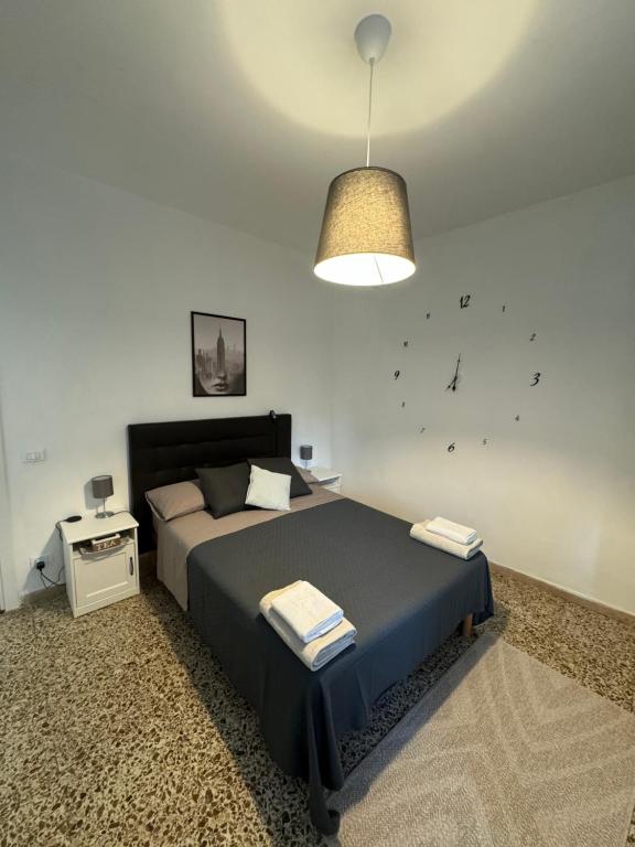 a bedroom with a large bed and a lamp at Pisa tower view 2 in Pisa