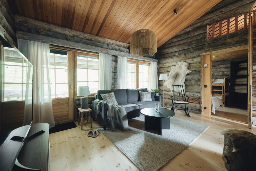 a living room with a couch and a table at Kelo Naava in Ruka