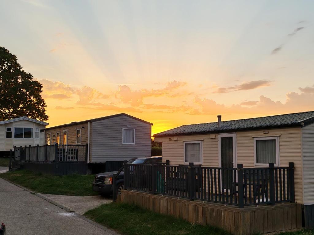 a house with a car parked in front of it at Sunnycott Caravan Park in Cowes