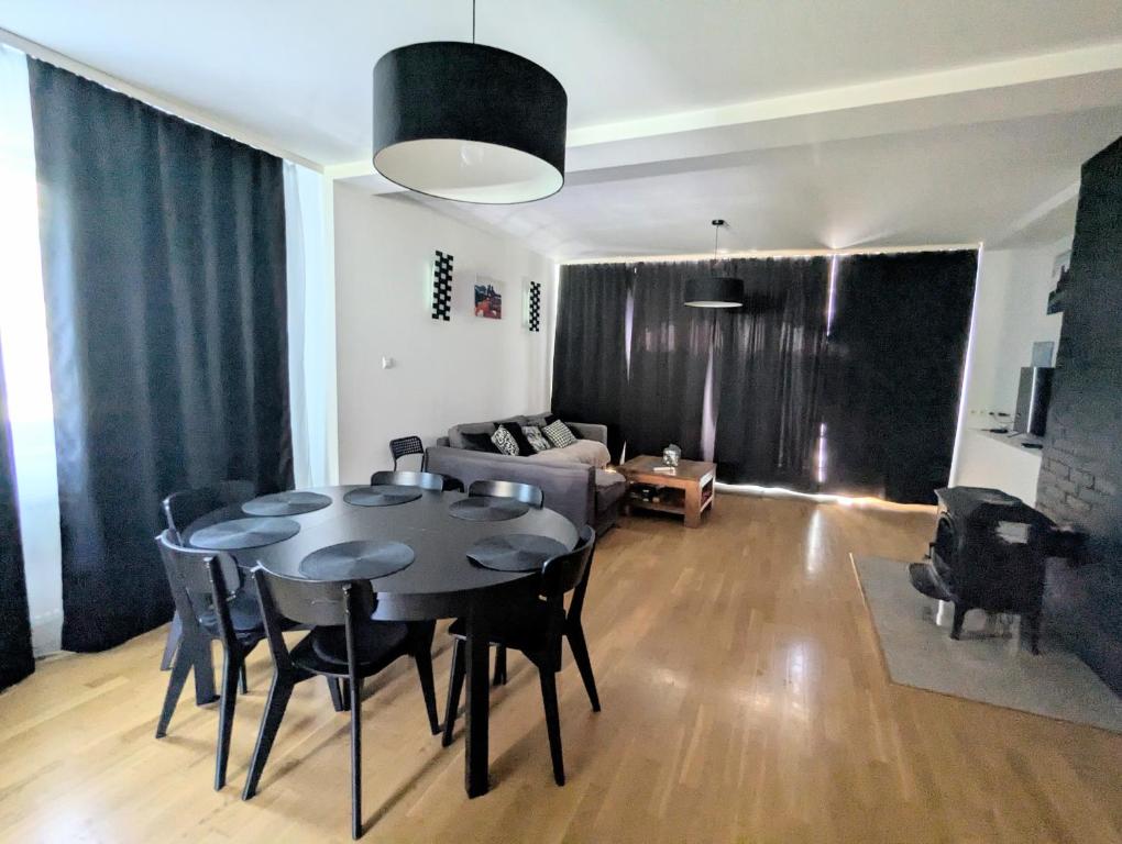a living room with a table and a couch at Ostań i Odpocznij Podzamcze in Podzamcze