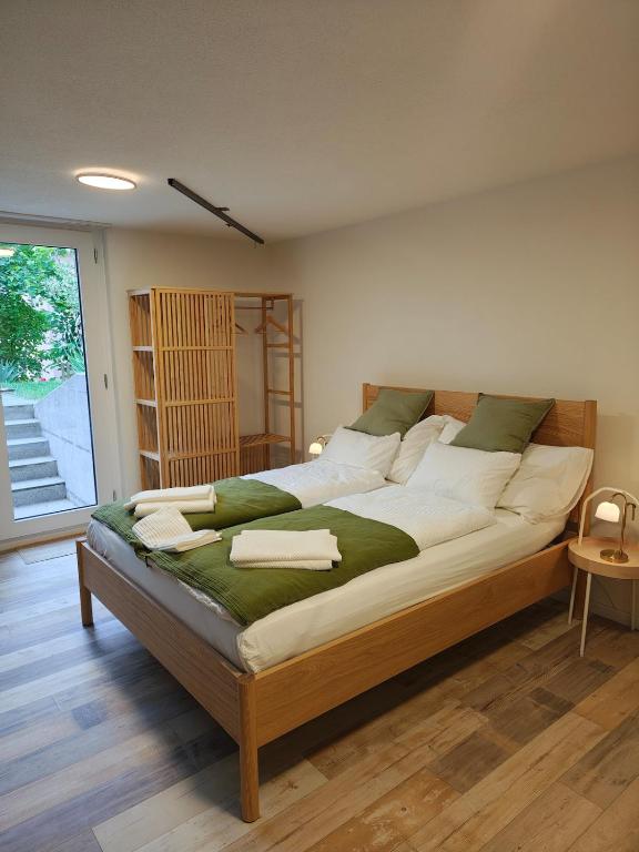 a large bed sitting in a room with at O&D Guest Room in Flurlingen