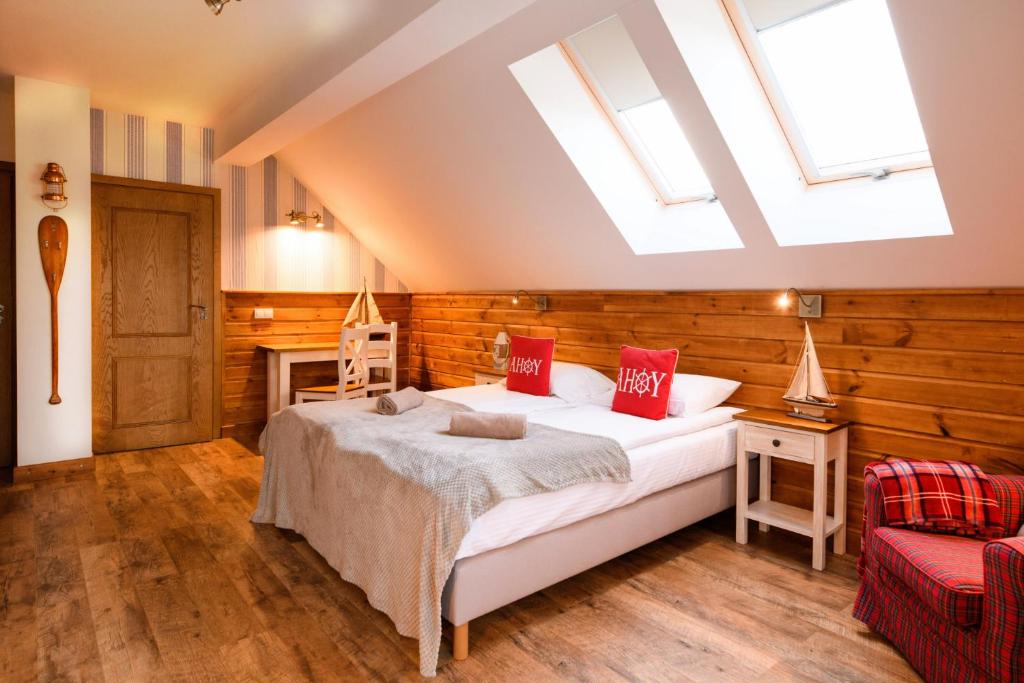 a bedroom with a bed and skylights at Ostoja Dwa Jeziora in Węgorzewo