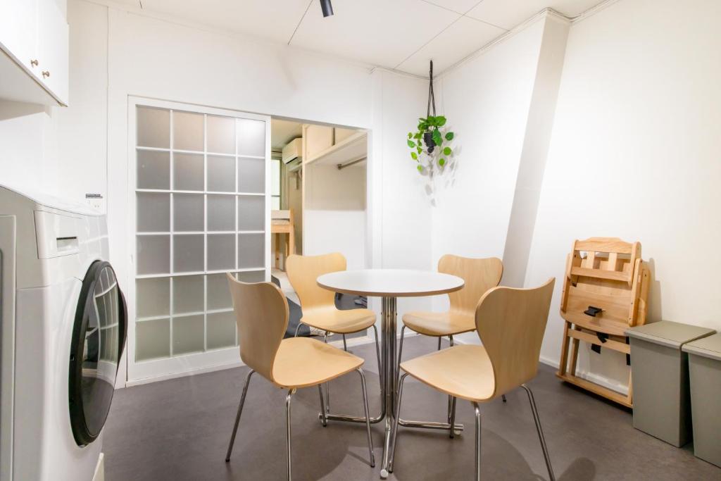 a dining room with a table and chairs at Epilogue Hotel 202 in Fukuoka