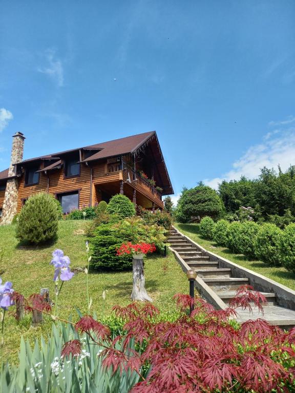 a house with stairs and flowers in front of it at Montebello Colibita in Colibiţa