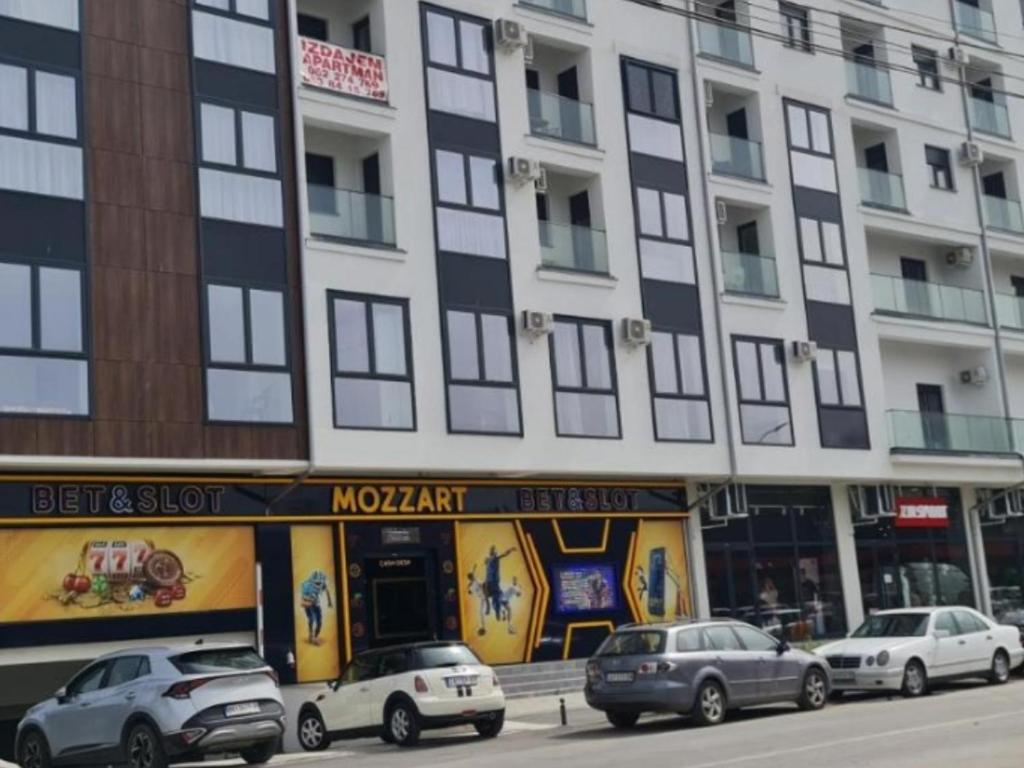a tall building with cars parked in front of it at Vivo in Jagodina