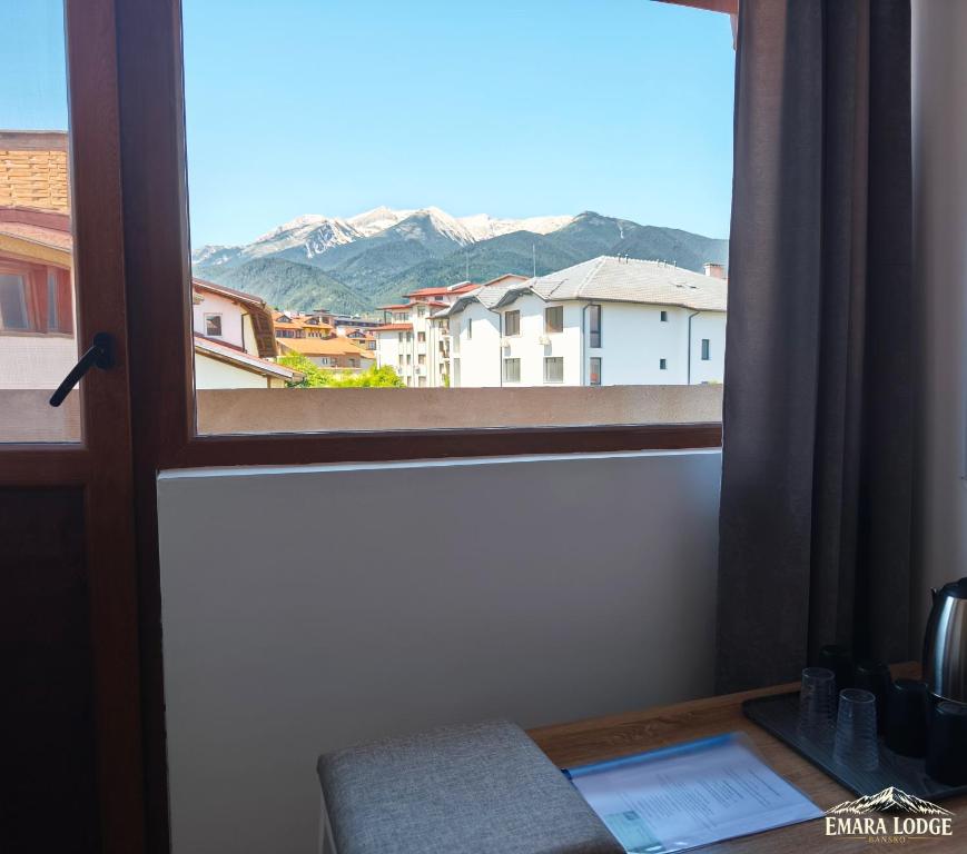 a window with a view of a mountain at Emara Lodge Bansko in Bansko