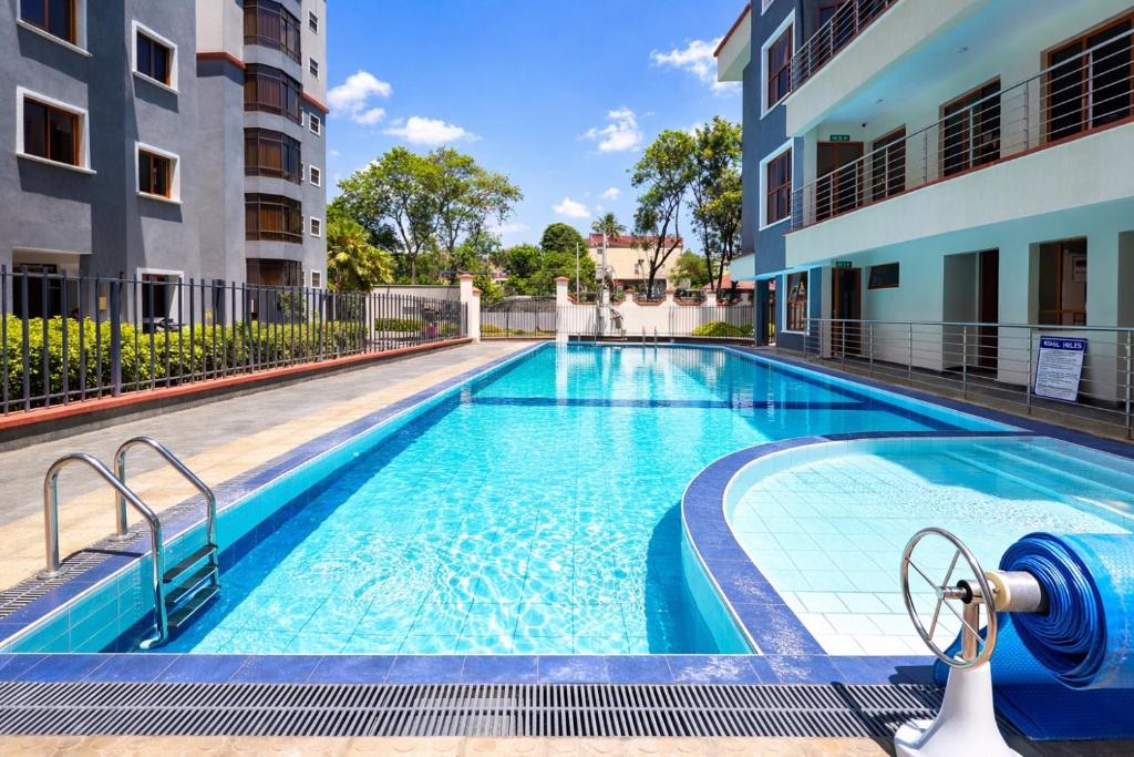 a swimming pool in the middle of a building at Shawmut Executive Suites With Heated Pool, GYM, Secure Parking, Full Power Backup in Nakuru