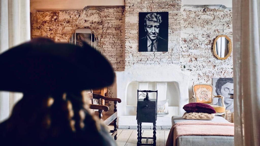 a woman is looking at a room with a bed at Legions Retreat in Antwerp