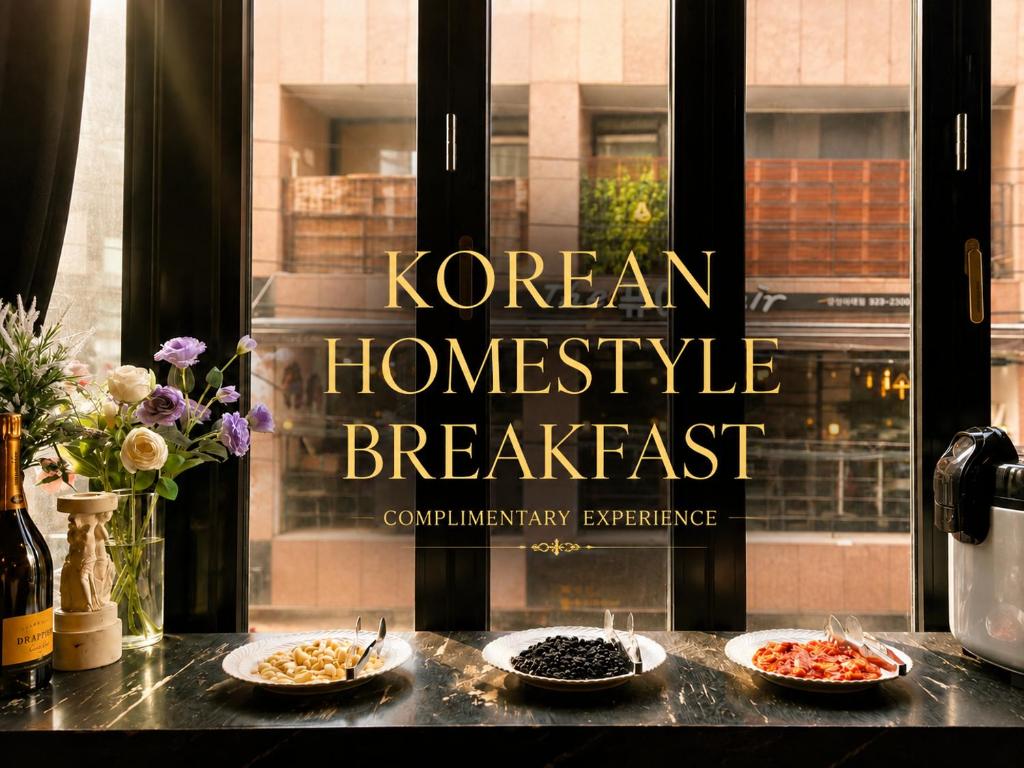 two plates of food sitting on a counter next to a window at Friendly DH Naissance Hotel by Mindrum Group in Seoul