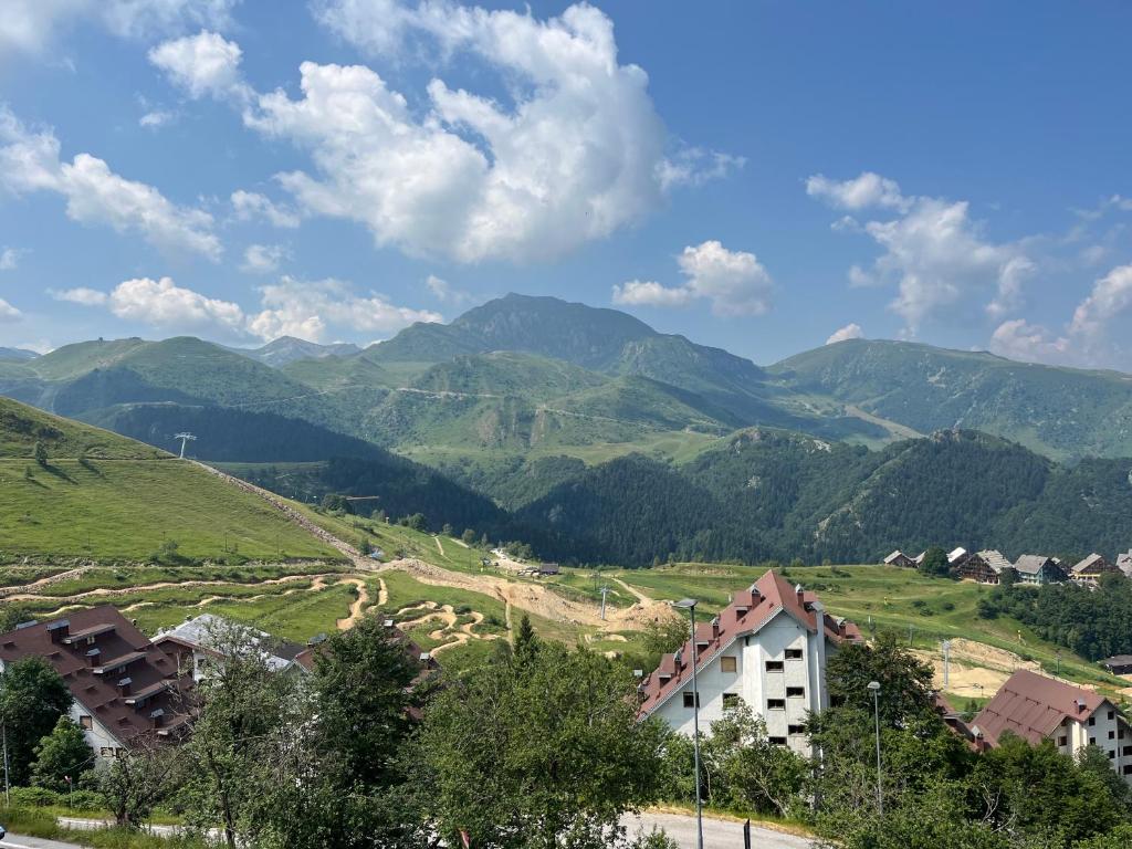 a view of a valley with mountains in the background at Monolocale Bellavista in Prato Nevoso