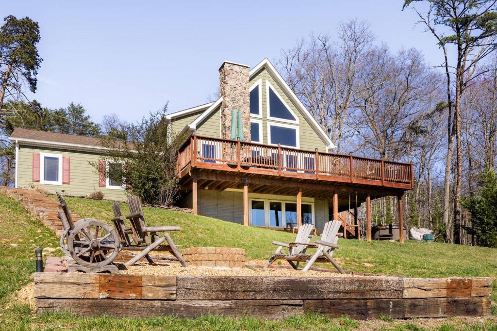 a house with a deck and chairs in front of it at Shenandoah Thunder Chalet Guest Suite in Front Royal
