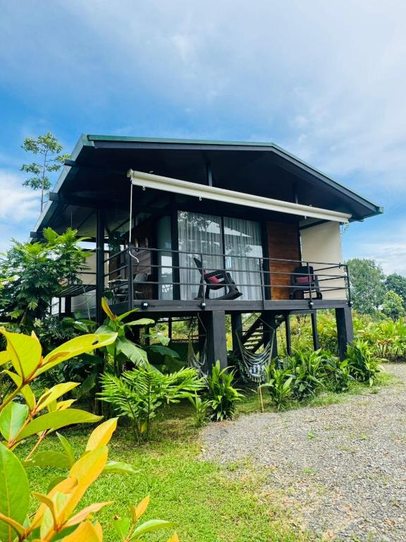 a small house with a black roof at Cabañas La Hermosa #2 in Guápiles