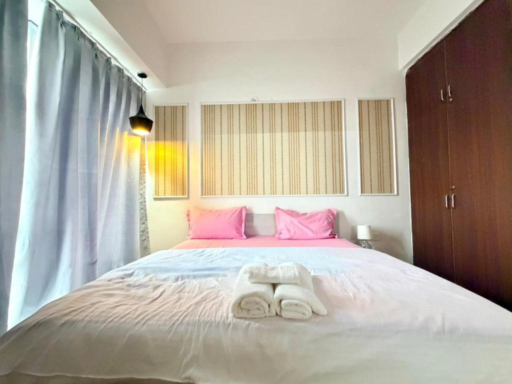 a bedroom with a bed with two towels on it at Sofitel Caravanserai 1BHK Noida, Spectrum Mall Sector 75 in Noida
