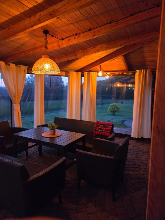 a patio with a table and chairs in a room at Agroturystyka u Kasi in Suryty