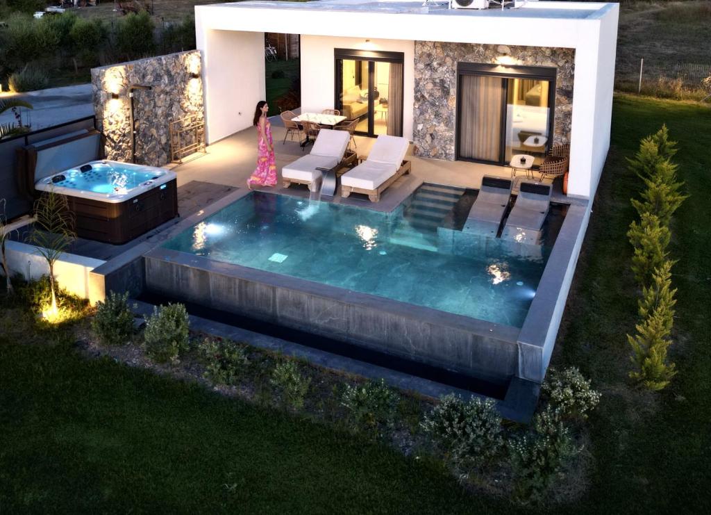 a swimming pool in the yard of a house at night at Aphrodite Luxury Villas & Suites-Private Heated Pool & Jacuzzi in Kos