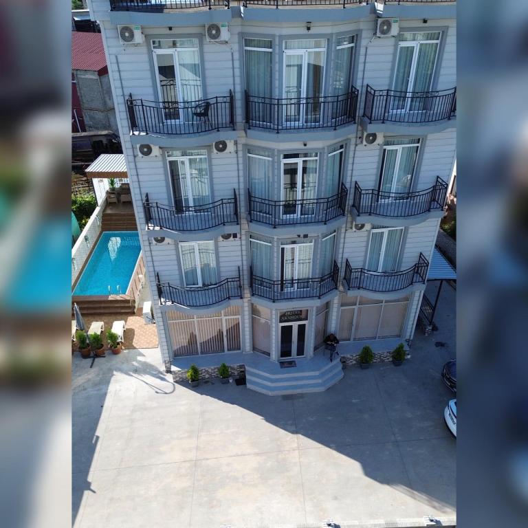 an overhead view of a building with balconies and a pool at SkyHouse Batumi in Batumi