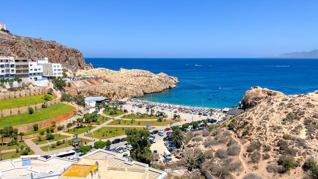 a view of a beach with the ocean and buildings at Belle cote appartement al hoceima in Al Hoceïma