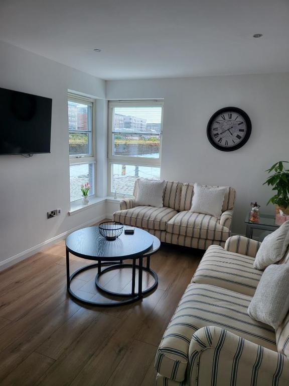 a living room with a couch and a table at Quayside Waters in Dundee