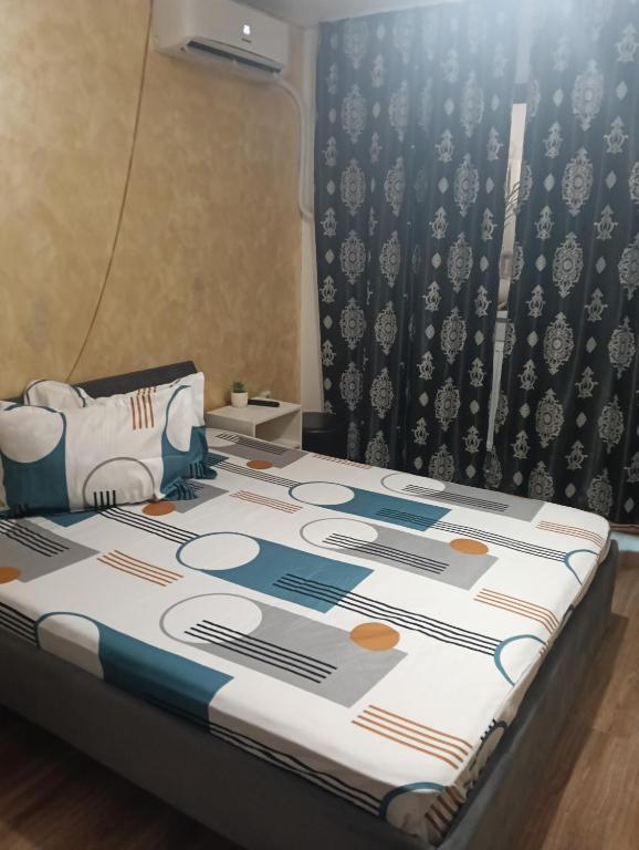 a bed in a room with a bedspread on it at casa lidia in Brăila