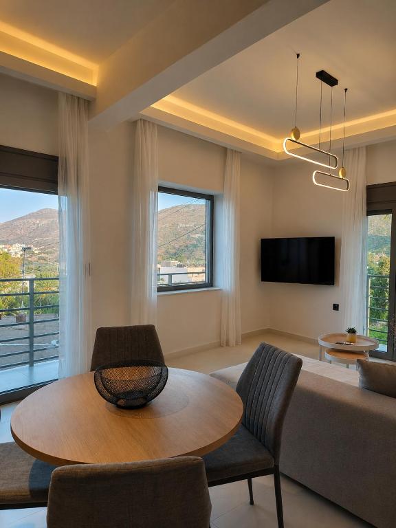 a living room with a table and a couch at Elina's Era Lounge Apartment in Palekastron
