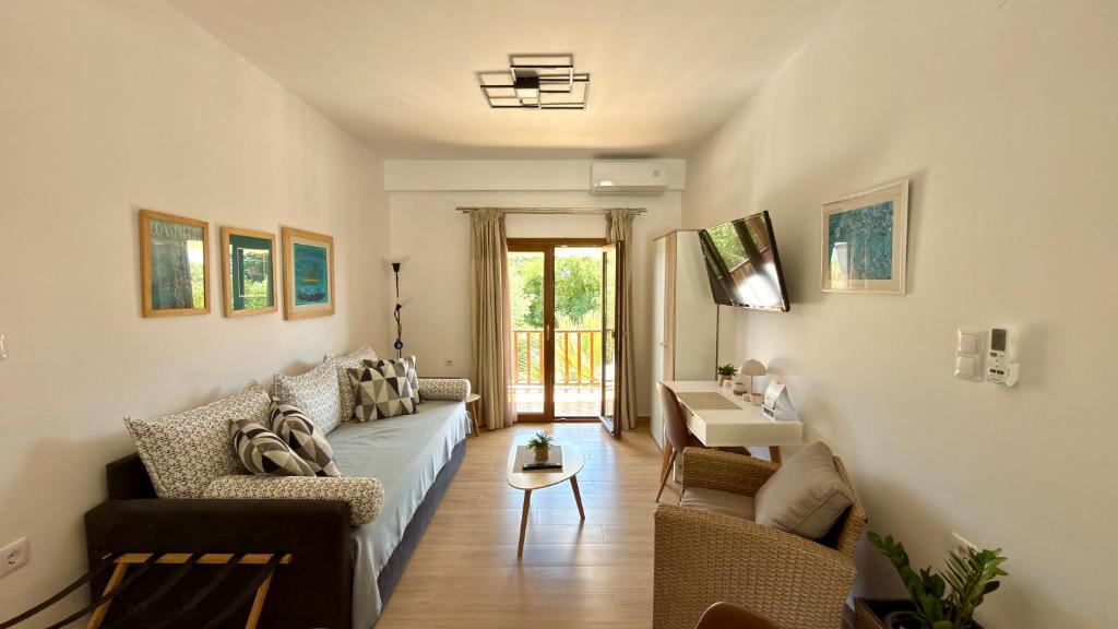 a living room with a couch and a table at Edem Haven Luxury Apartment in Skala Fourkas