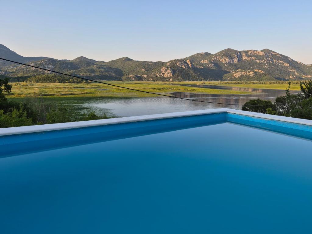 a pool with a view of a river and mountains at LAKE VIEW PREVLAKA in Cetinje