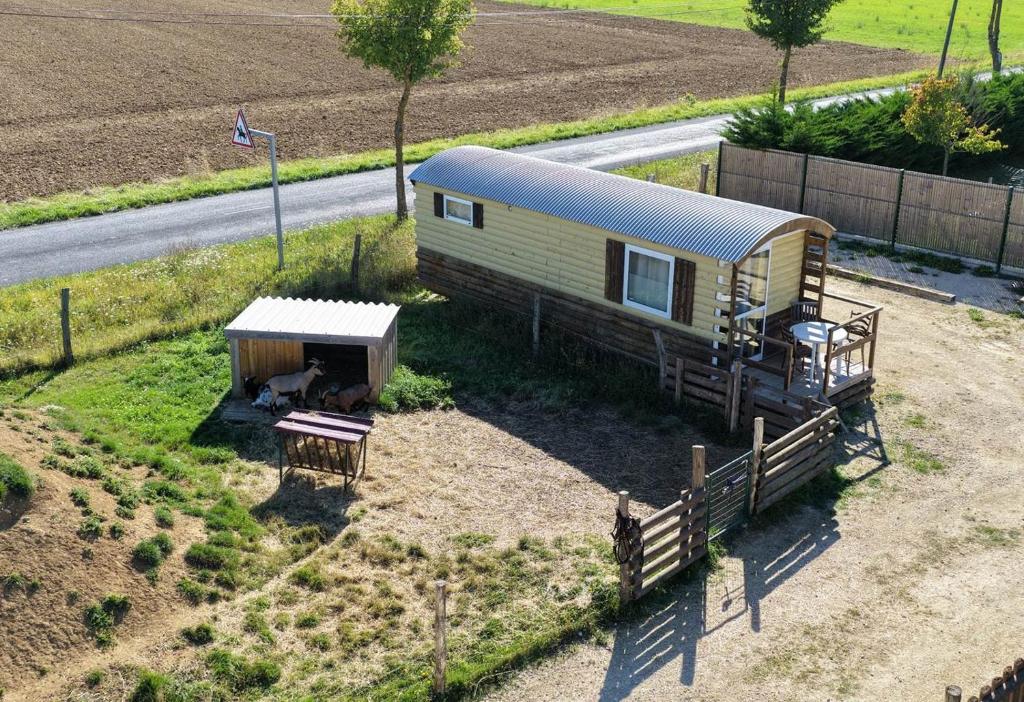an aerial view of a tiny house in a field at Roulotte tout confort au milieu des animaux in Burthecourt-aux-Chênes