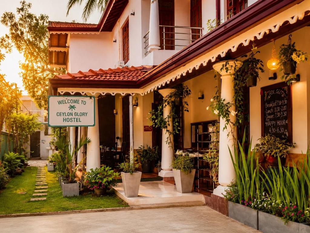 a building with a sign that reads welcome to century city hotel at Ceylon Glory Hostel in Negombo