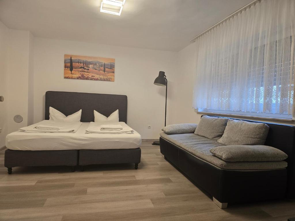 a bedroom with a bed and a couch at Green House in Haibach