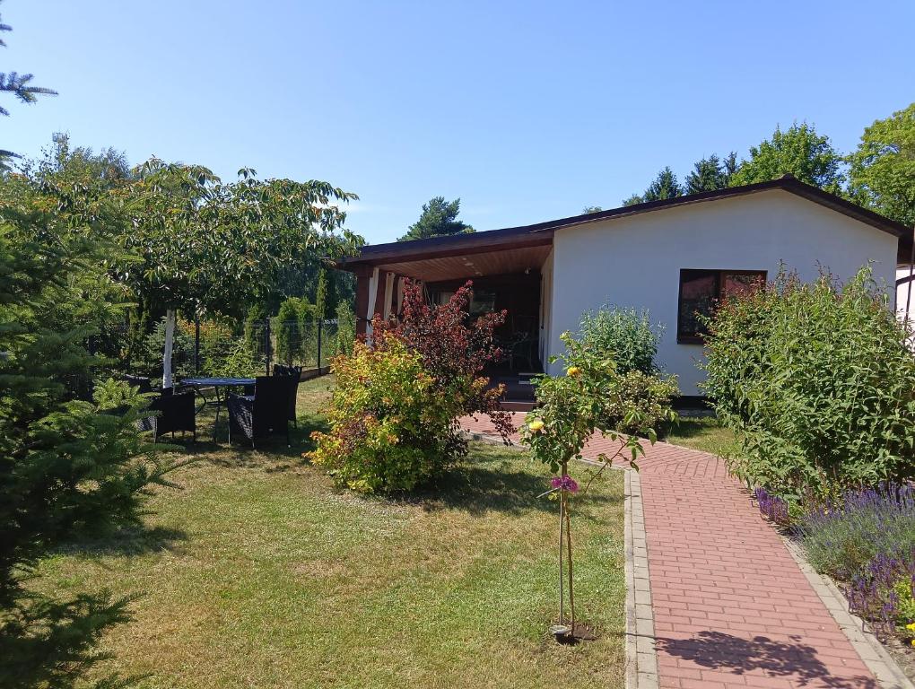 a house with a brick path in front of it at Zacisze in Kołczewo