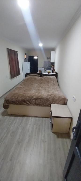 a bedroom with a large bed in a room at Meghri Hotel in Meghri