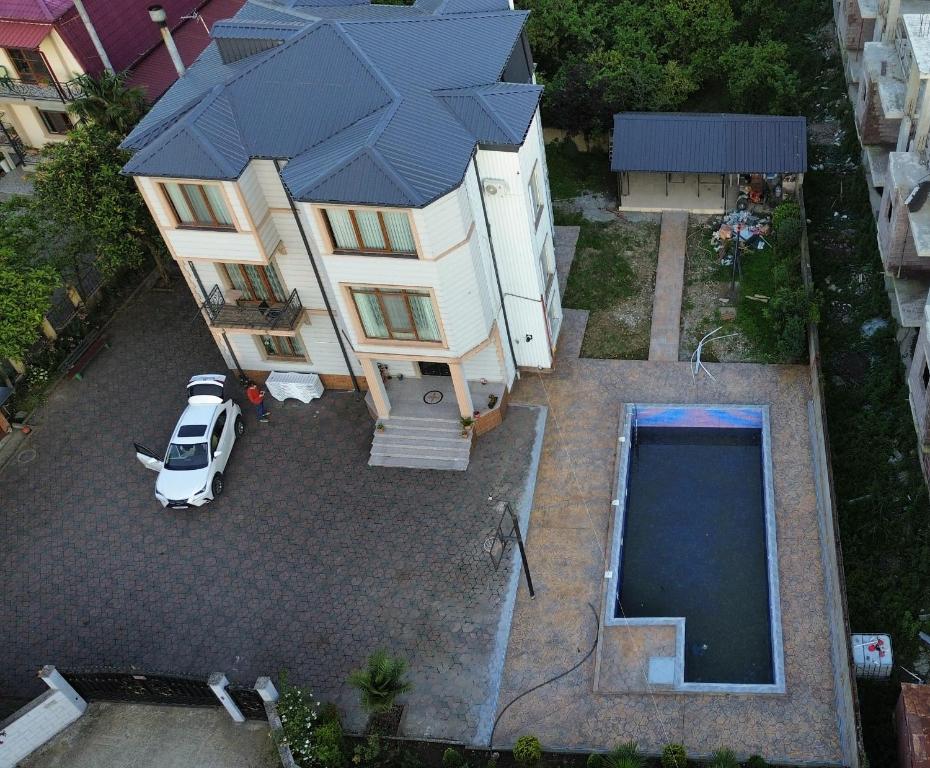 an aerial view of a house with a swimming pool at Jumber&Lela in Batumi