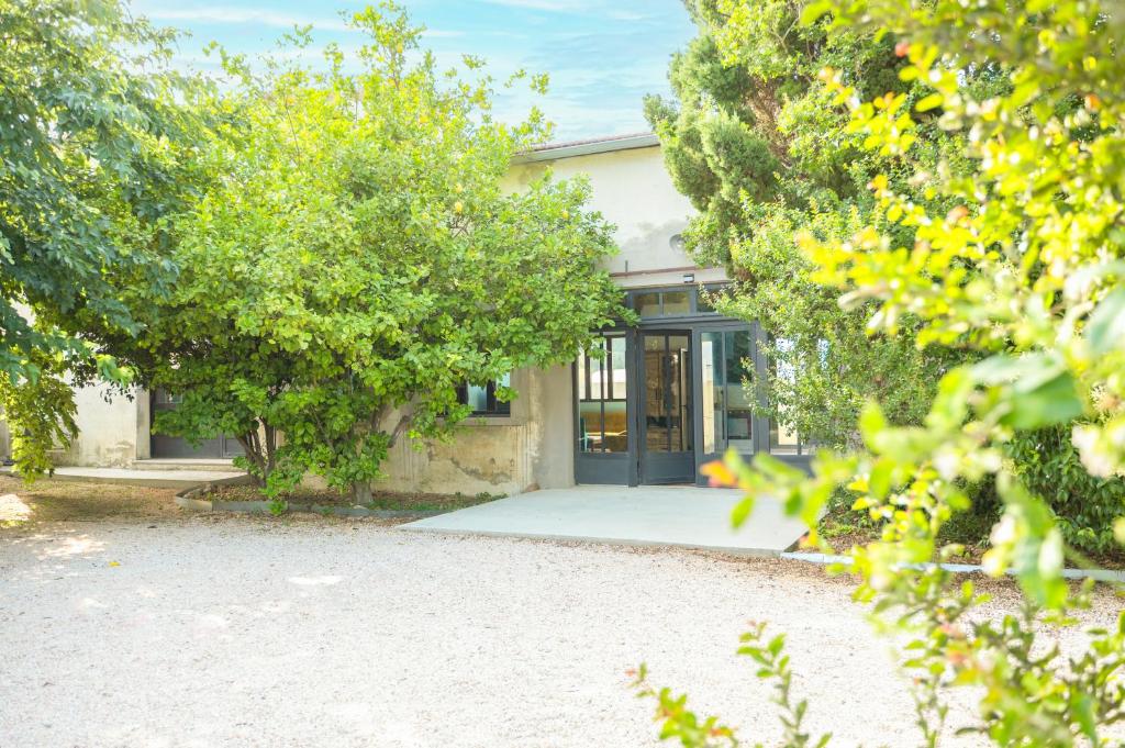 a house with a driveway and trees in front of it at Campagne et Mer in Perpignan