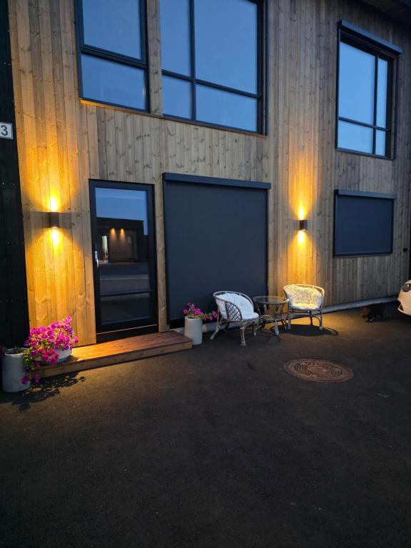 a room with two chairs and a table and lights at Fjordstay in Vennesla