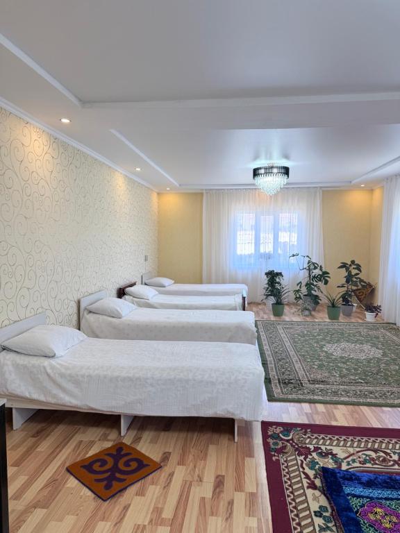 a room with a row of beds in it at Dan guest house in Pokrovka