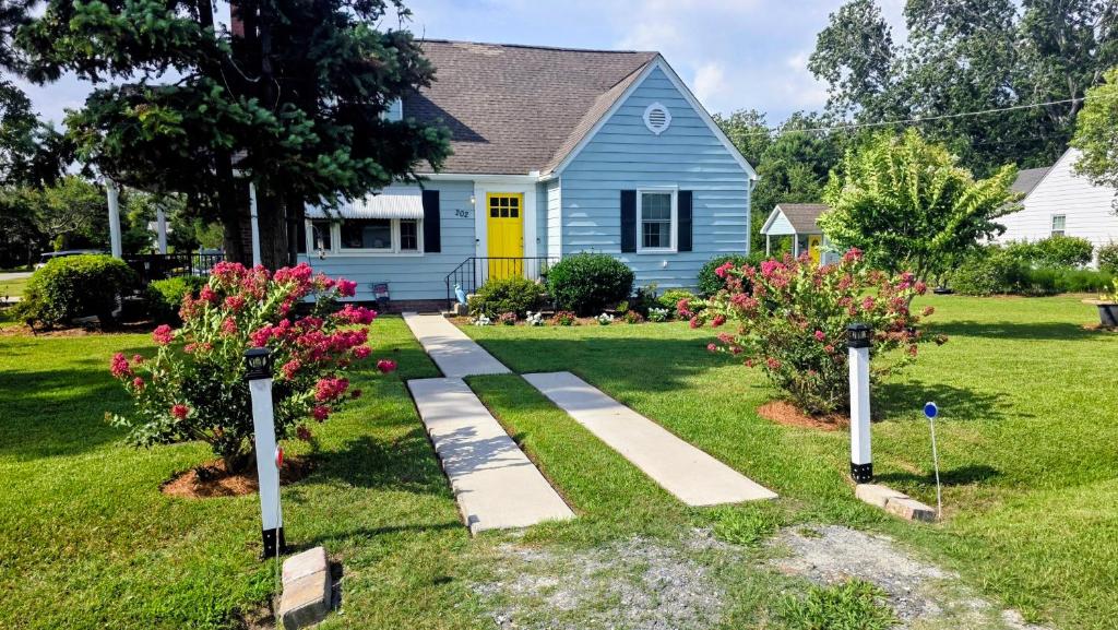a house with a pathway in front of a yard at A Salter's Path in Beaufort
