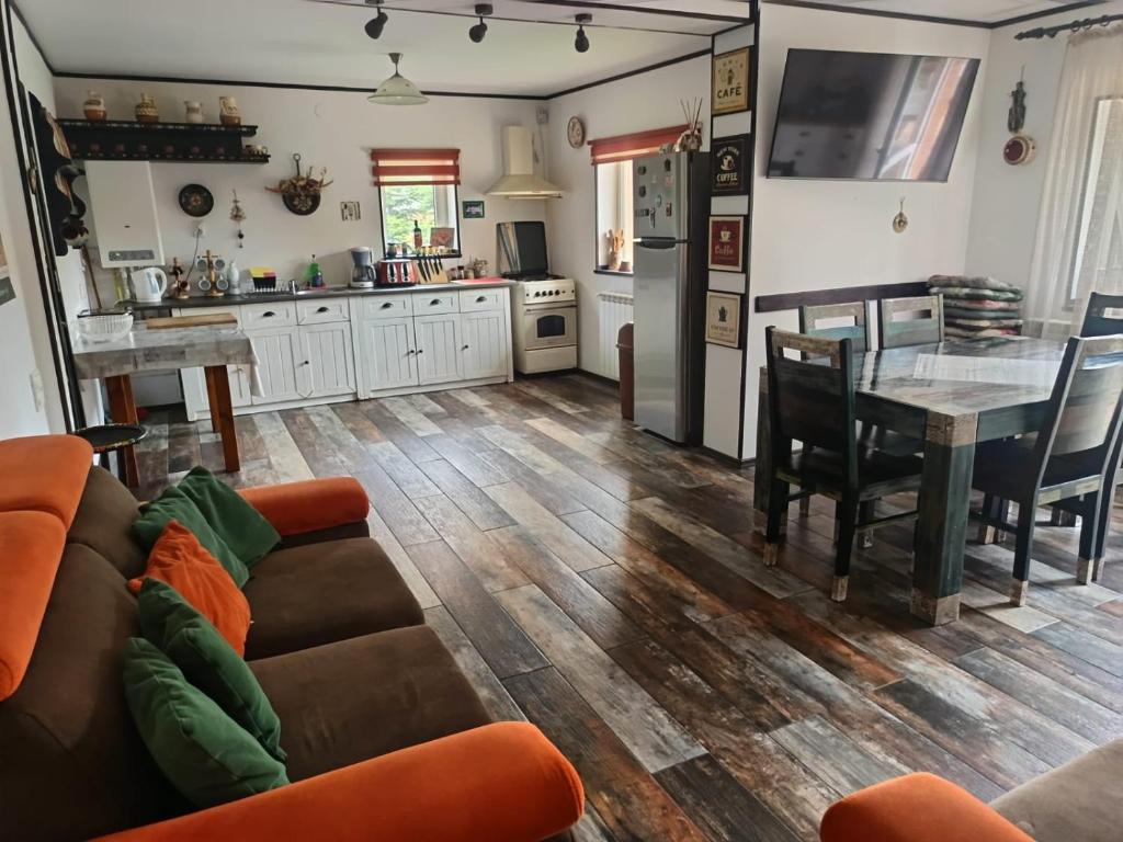 a living room with a couch and a table at CASA de VIS in Sinaia