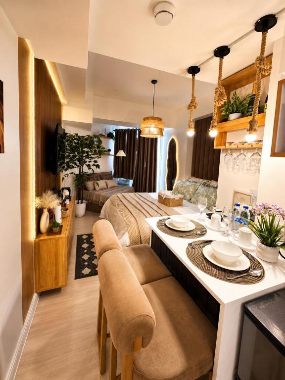 a living room with a bed and a dining table at Sky26 Stays by Paula & Hudson in Pampang