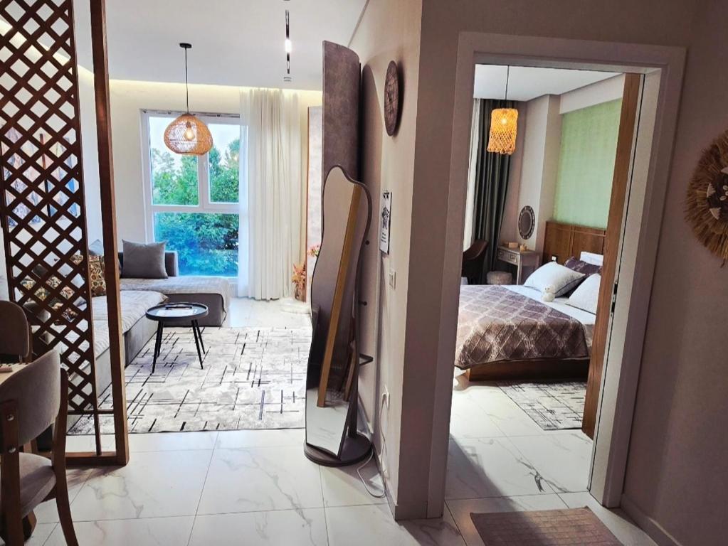 a bedroom with a bed and a living room at 60 seconds walk to the Beach in Golem