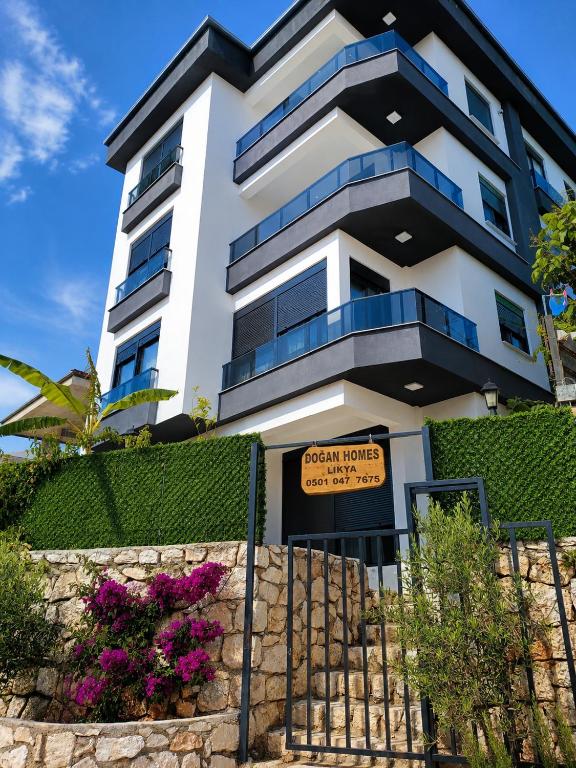 a building with a sign in front of it at Doğan Homes Likya in Demre