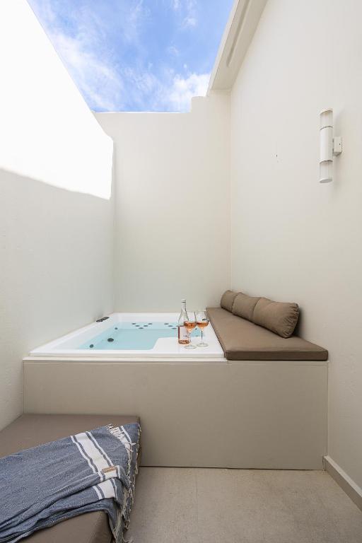 a bath tub in a room with a window at Bliss House in Rethymno