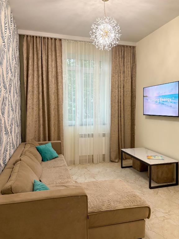 a living room with a couch and a table at S-Van Cozy Home in Sevan