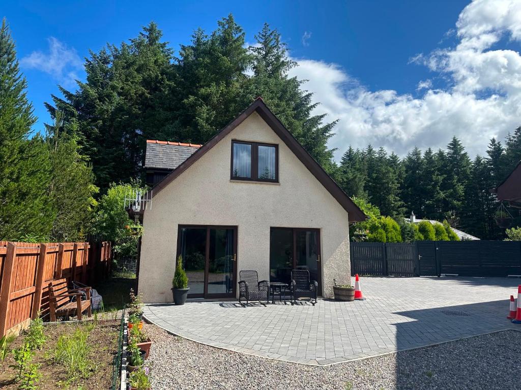 a small house with a patio in a yard at Thistle Do Fort William in Fort William