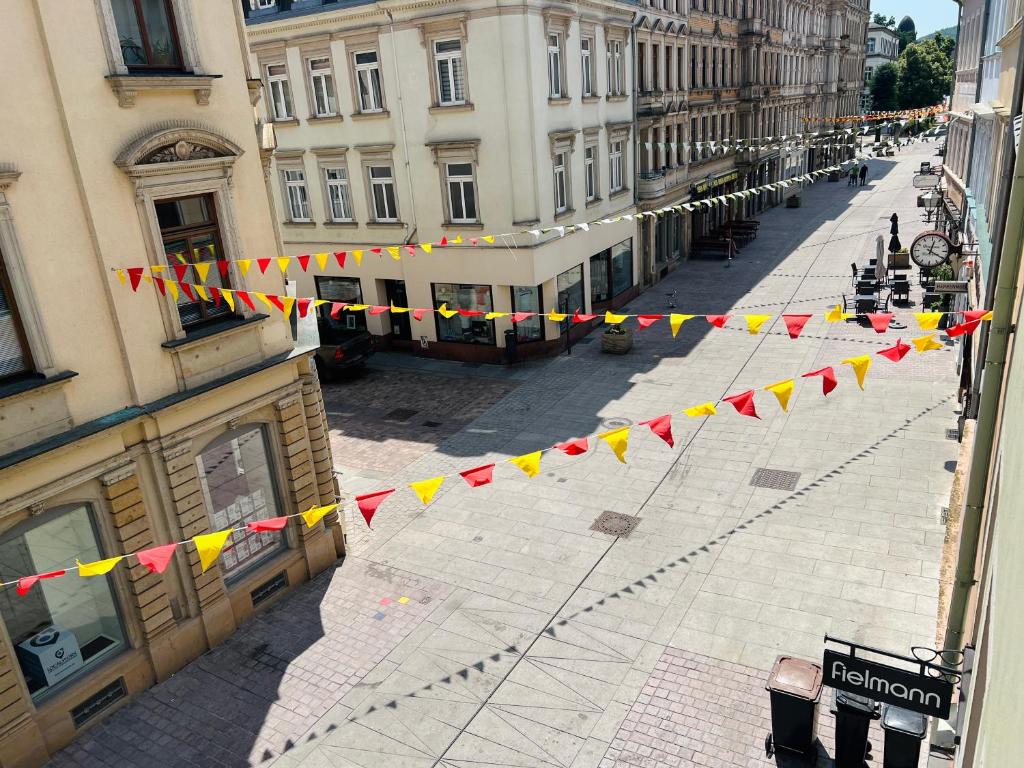 an empty street with flags in a city at Altstadt Loft - Im Herzen der Altstadt - TREVIET in Pirna