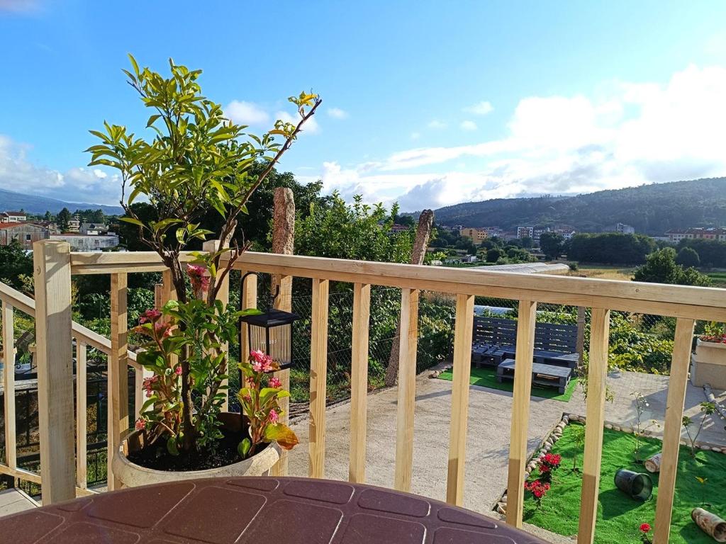 a balcony with a table and a view of a city at Aldea de Rosalía in Padrón