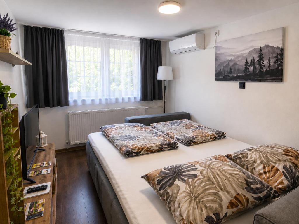 a bedroom with two beds with pillows on them at Romantic Mirka Apartment in Sremski Karlovci in Sremski Karlovci