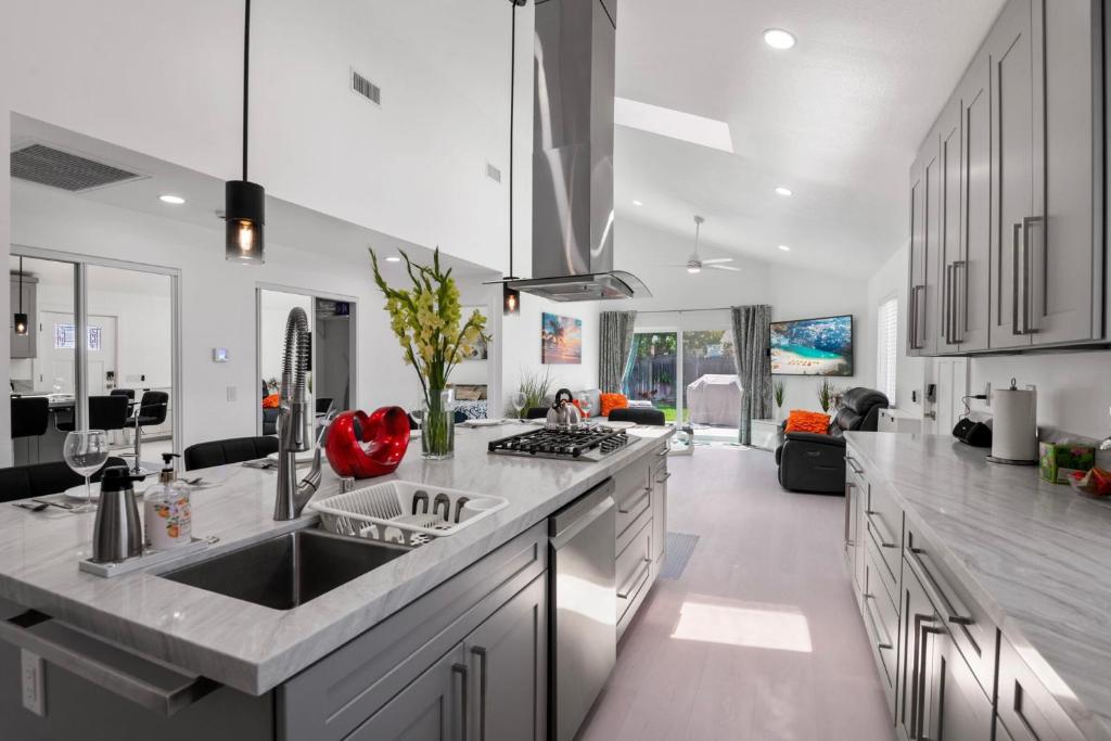 a kitchen with a sink and a stove top oven at Luxury New Build Bright 2BR 2BA Large Backyard in Mission Viejo